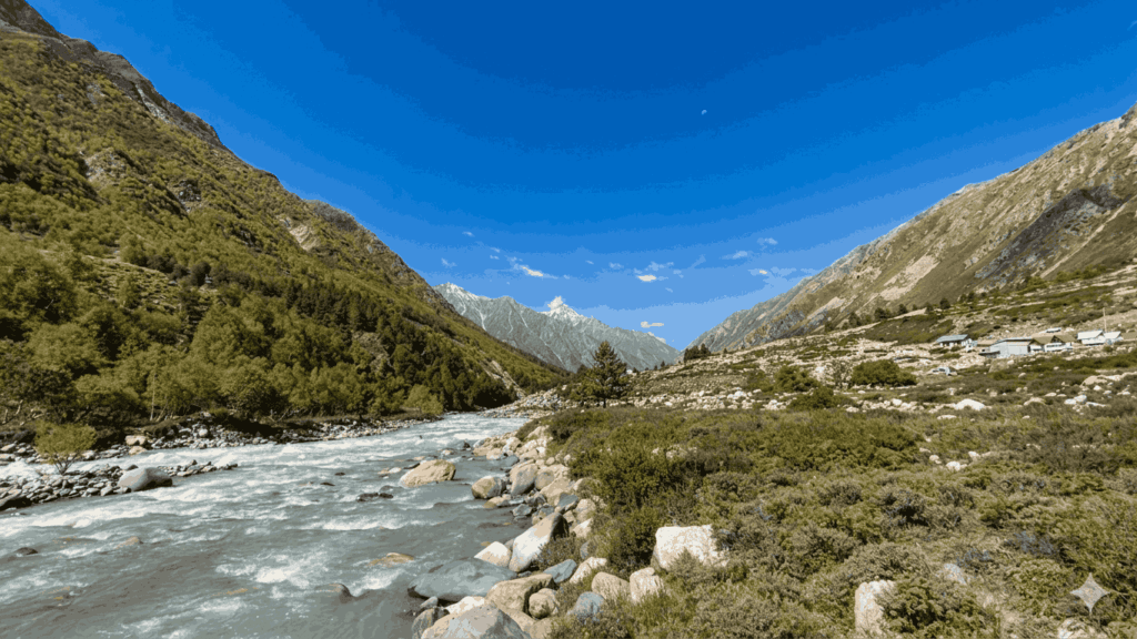 The Baspa River flowing through Chitkul village in Himachal Pradesh, the last inhabited village near the border, featured as one of the best places to visit in May in India 2026.