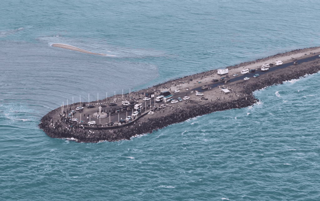 Aerial view of the road to Arichal Munai in Dhanushkodi where the two oceans meet, featured as one of the best places to visit in May in India 2026.