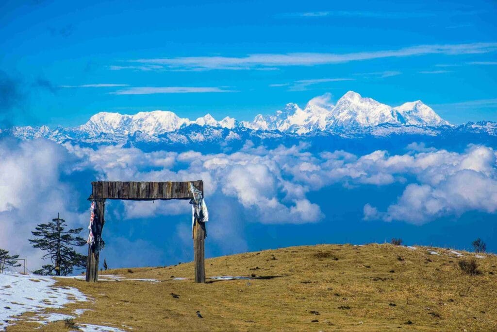 The snow-capped Himalayan peaks of Kanchenjunga seen from the Sandakphu trek summit, featured as one of the best places to visit in May in India 2026 for trekking and mountain views
