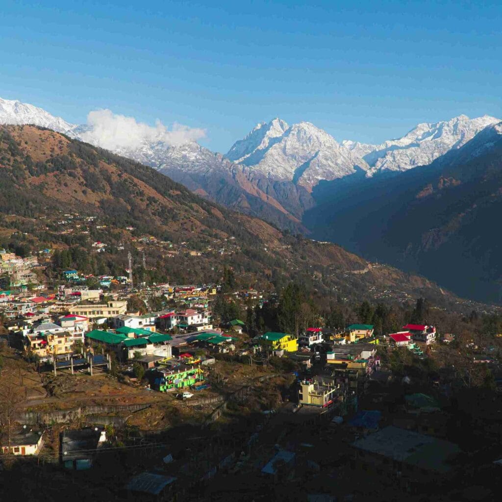 Scenic mountain village of Munsiyari with snow-capped Panchachuli peaks in the background, one of the best places to visit in May in India 2026.