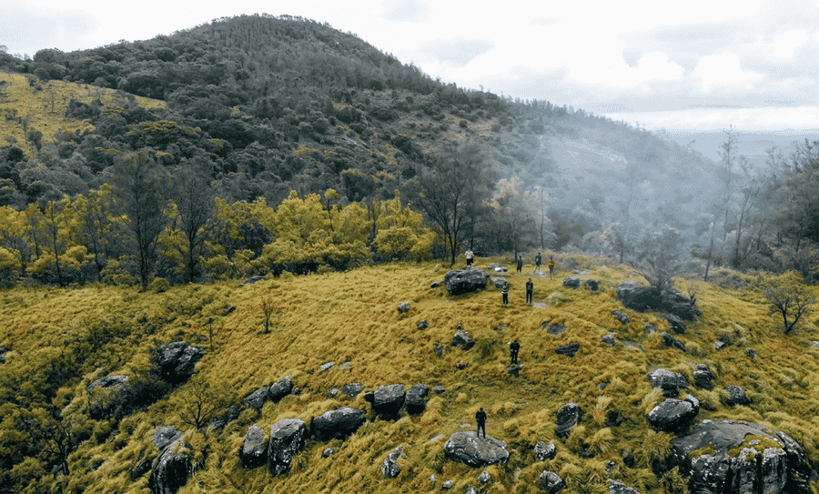 "A breathtaking aerial view of the misty mountain peaks and lush trekking trails in Kakkabe, Coorg, listed as one of the 13 best places to visit in August in India 2026."
