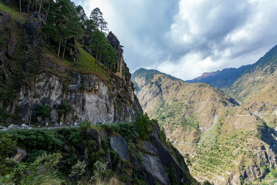19 Best Places to Visit in December 2026: A dramatic view of the steep rocky cliffs and winding mountain roads of Sangla Valley in Kinnaur, Himachal Pradesh.