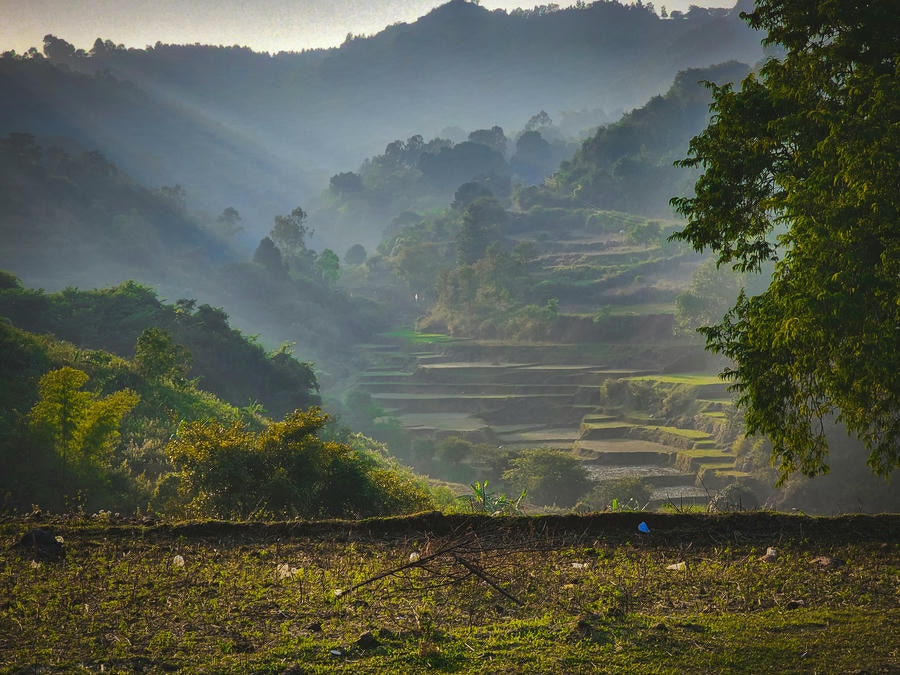 Araku Valley Sunbeams streaming through misty mountain valleys onto stepped terrace fields, featured in our guide to the 21 best places to visit in south.