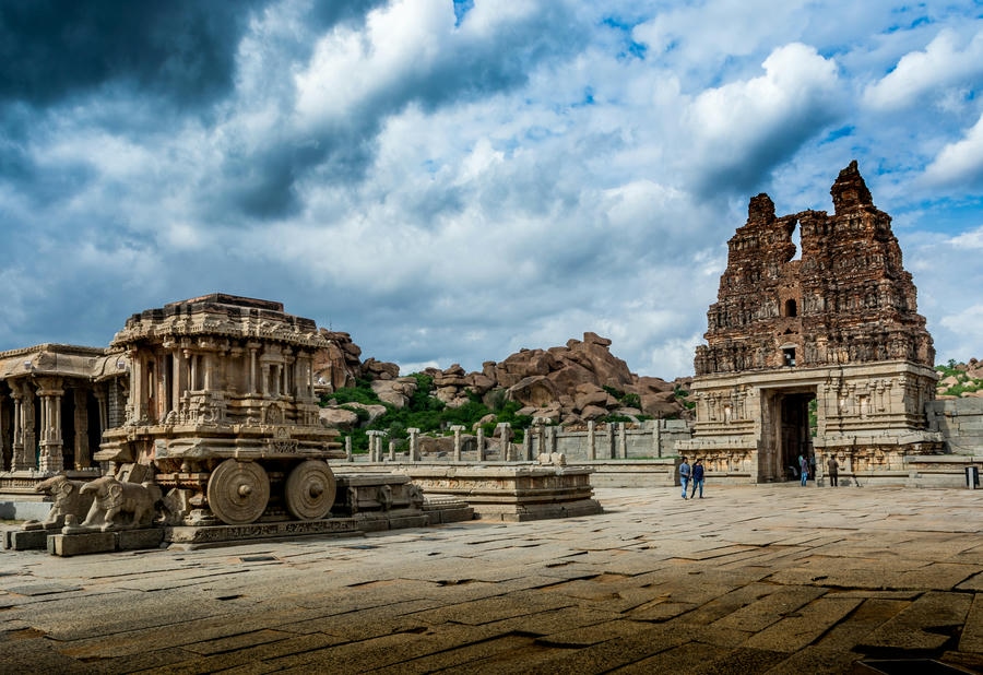 The historic Stone Chariot and ancient temple ruins of Hampi under a dramatic sky, representing one of the 21 best places to visit in south.