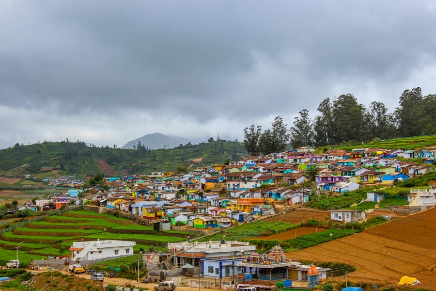 A vibrant village with colorful houses built on the stepped terraces of Ooty, highlighting the 21 best places to visit in South India.