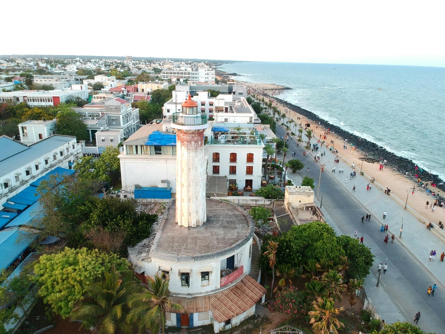 An aerial view of the historic old lighthouse and beach promenade in Pondicherry, showcasing one of the 21 best places to visit in south.