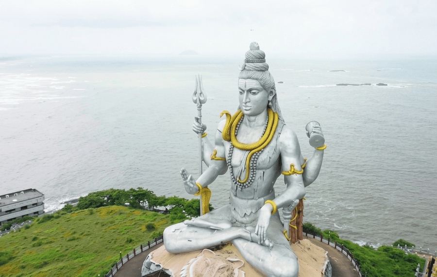 Gigantic silver Shiva statue perched on Kanduka Hill overlooking the ocean, highlighted among the best places to visit South India on coastal Karnataka itineraries.