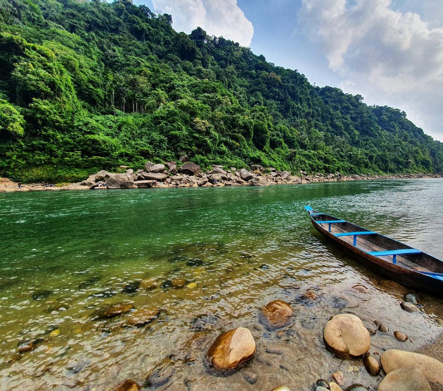 A wooden boat on the crystal clear waters of the Umngot River in Dawki, Meghalaya, one of the 19 best places to visit in December 2026.