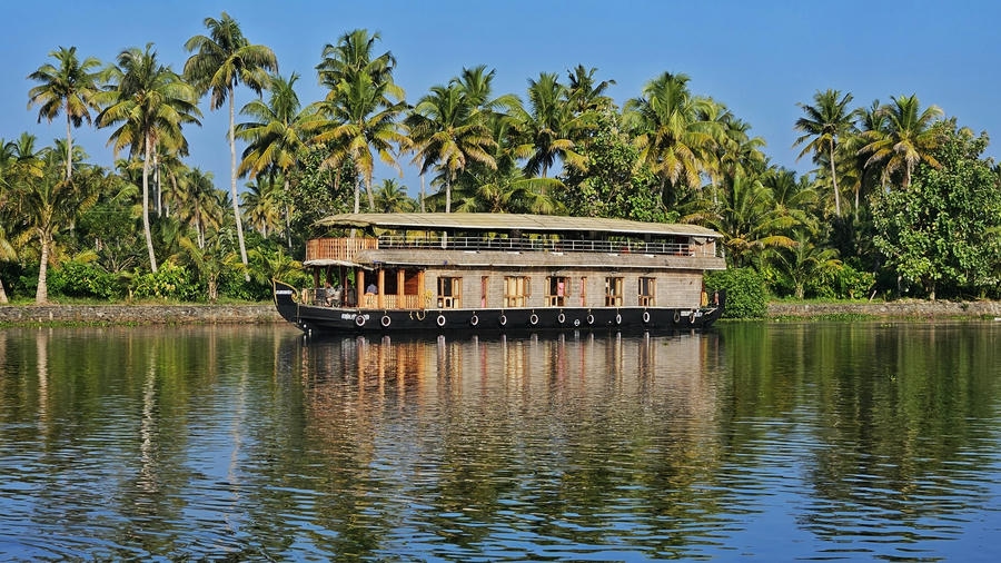 A traditional Kerala houseboat cruising through the calm backwaters of Kumarakom, one of the 15 best places to visit in November in India 2026.