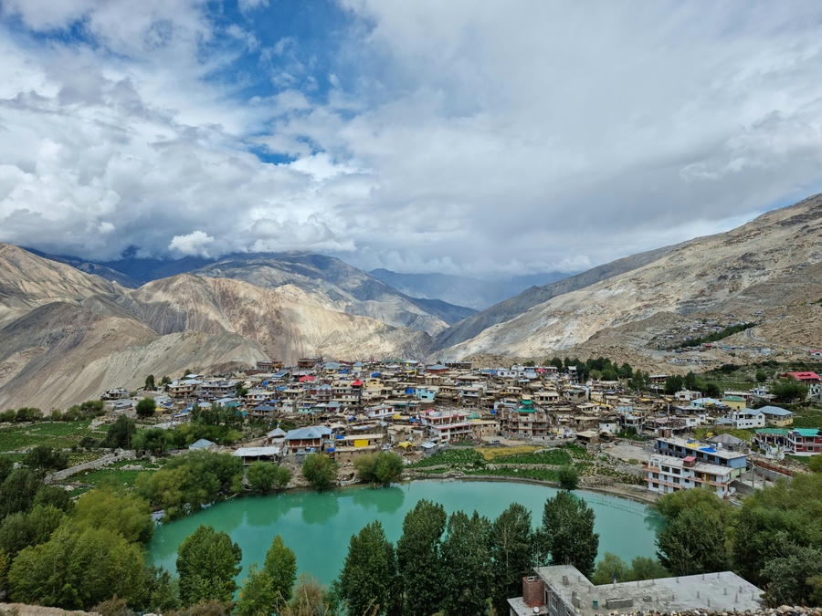 Aerial view of Nako Village and its turquoise lake surrounded by the rugged Himalayan mountains of Kinnaur, featured in the 19 best places to visit in December 2026.