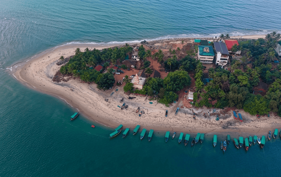 An aerial shot of the pristine coastline and turquoise waters of Tarkarli, Maharashtra, listed as one of the 15 best places to visit in November in India 2026.