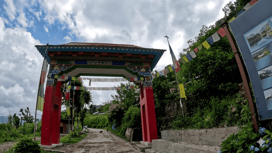The iconic traditional entrance gate to Yuksom, the first capital of Sikkim, making it one of the 19 best places to visit in December for its rich history and peaceful mountain setting.
