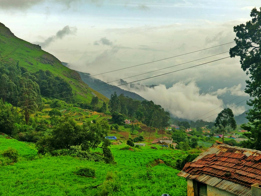 Lush green hills and village landscape in Ooty, featured among the best hill stations in South India 2026.