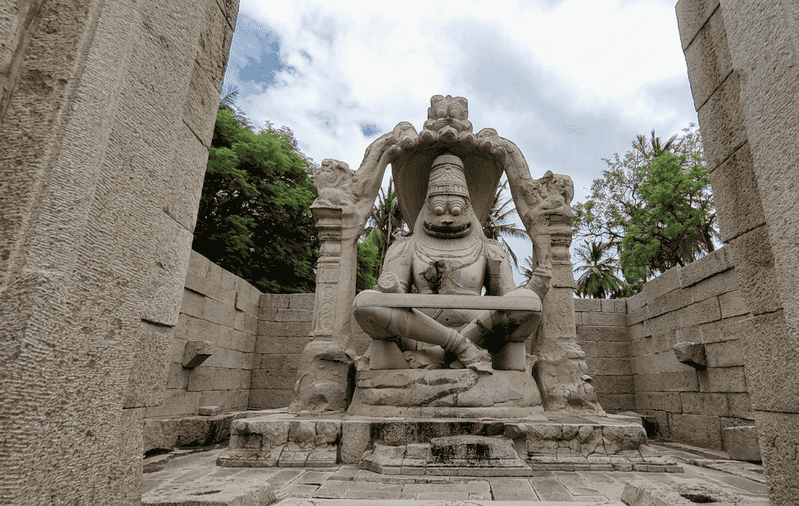 The monumental monolithic statue at Lakshmi Narasimha Temple, one of the best places to visit in Hampi.