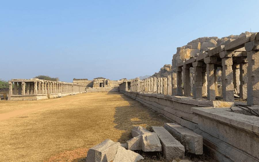 A wide-angle view of the historic Hampi Bazaar mandapams leading toward the main temple, one of the best places to visit in Hampi.