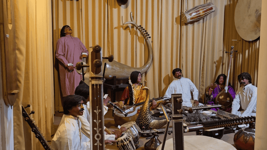 Diorama inside the Melody World Wax Museum showing lifelike figures playing a variety of traditional Indian musical instruments, ranked among the 19 best places to visit in Mysore.