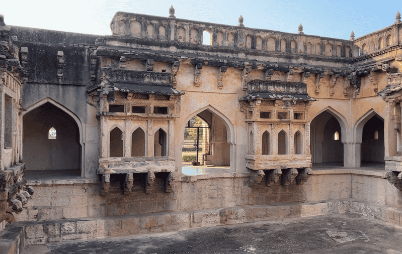 Queens Bath interior featuring ancient arched balconies, one of the best places to visit in Hampi.