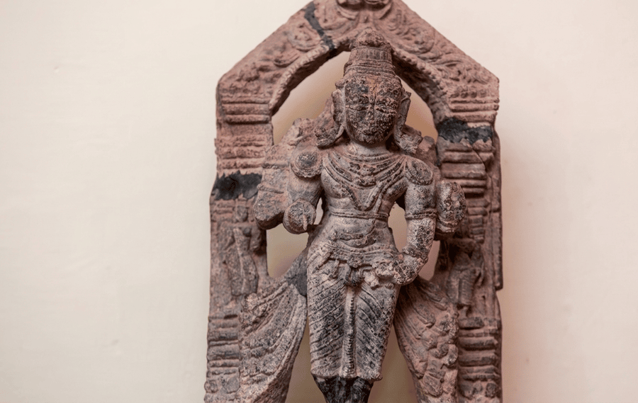 An ancient carved stone idol displayed at the Wayanad Heritage Museum (Ambalavayal), featured as one of the Best Places to Visit in Wayanad for history and culture.