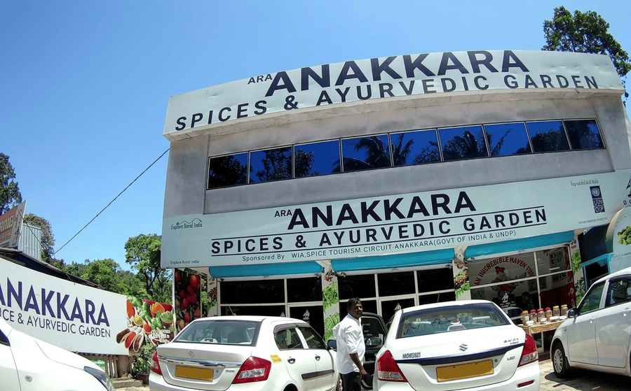 Tour vehicles parked outside the Anakkara Spices and Ayurvedic Garden center, highlighted among the best places to visit Thekkady.