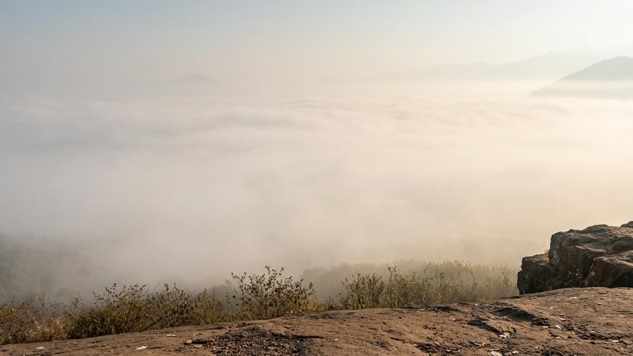 A high-altitude viewpoint looking over a vast sea of clouds filling a valley at sunrise from Madagada Sunrise Point, one of the best places to visit in Araku Valley.