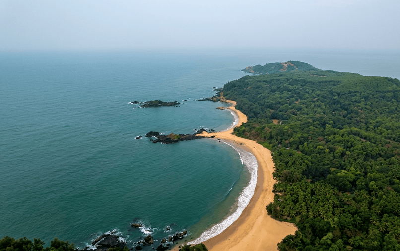 Aerial view of the naturally formed Om-shaped golden sand beach in Gokarna - best places to visit Gokarna guide