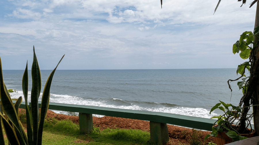 A scenic view of Papanasam Beach from a cliffside resort, a top highlight among the best places to visit in Varkala.