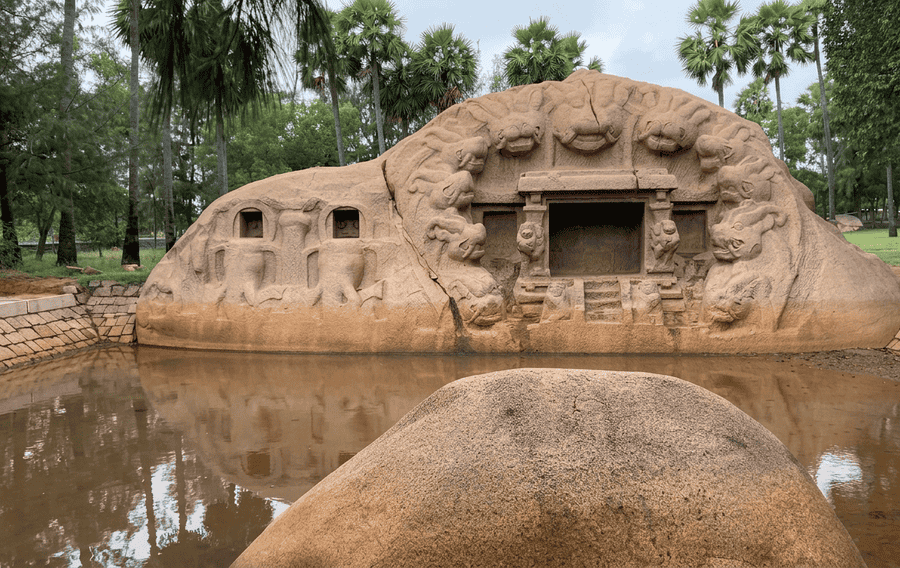 The massive monolithic Tiger Cave (Saluvankuppam) with its iconic yali or lion head carvings, standing at the edge of a pond near Mahabalipuram, is one of the best places to visit in Mahabalipuram.