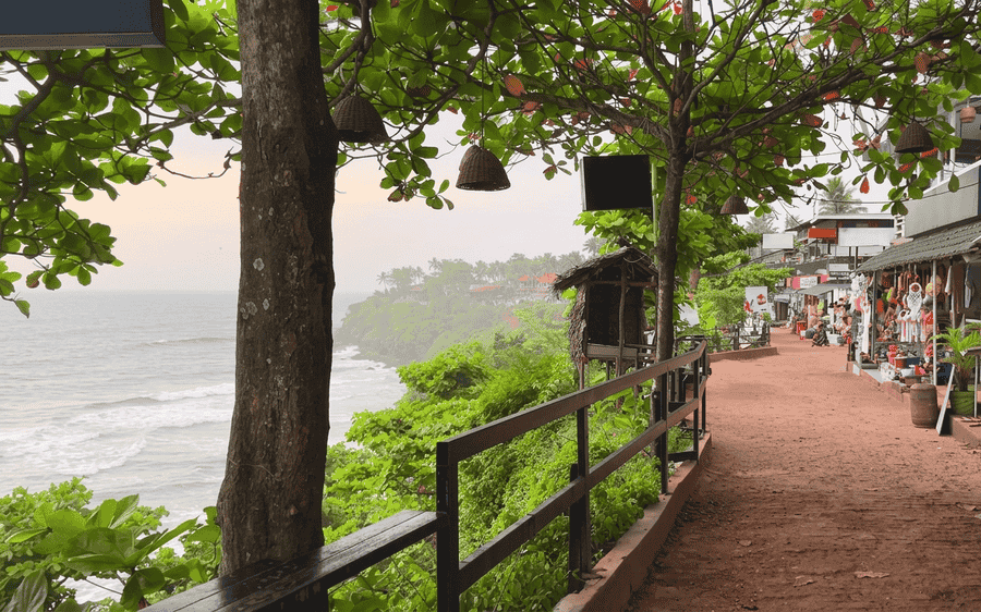 Scenic Varkala Cliff path lined with greenery and ocean views - best places to visit Varkala guide