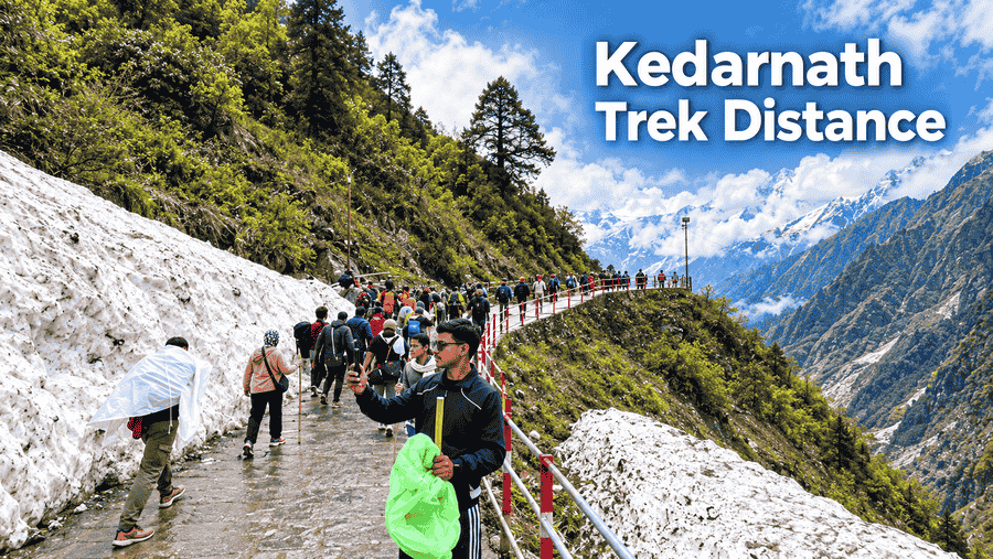 Kedarnath trek distance – Pilgrims walking along a snowy mountain trail in Kedarnath, Uttarakhand